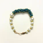 Elegant Pearl and Blue Bead Embellished Bracelet with Gold-Toned Clasp