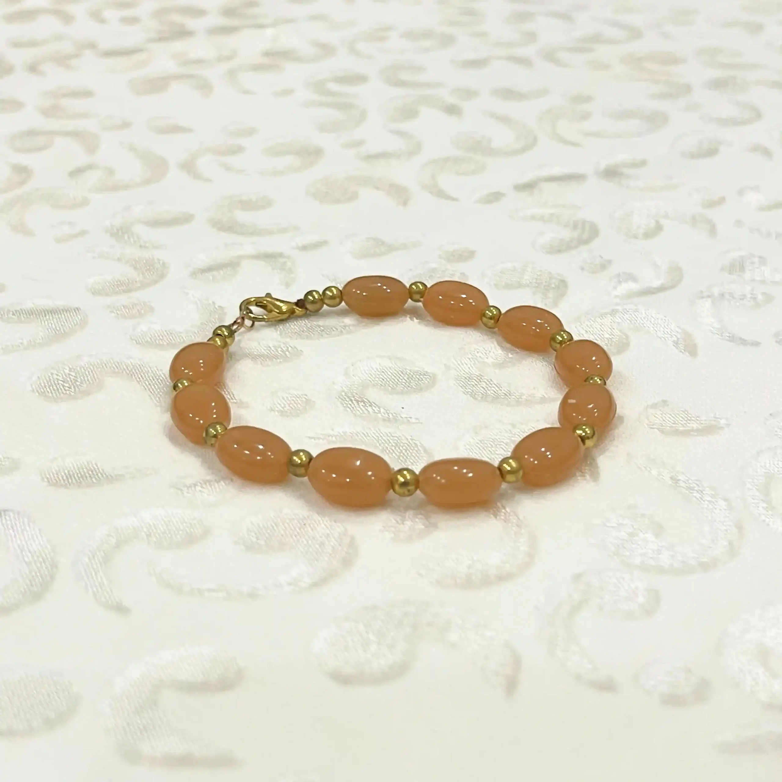 Peach Oval Bead Bracelet with Gold-Tone Accents